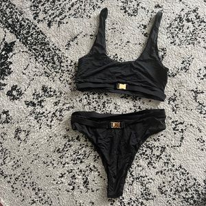 Meshki black swimsuit with gold buckles